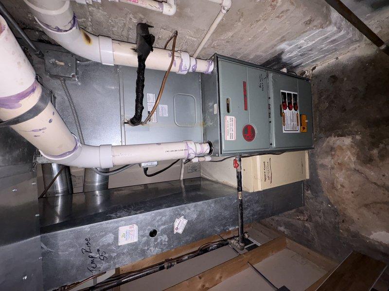 Completed full replacement of two 27-year-old HVAC systems in basement utility space. Installation included new furnace/air handler units, electrical disconnect panels with proper grounding, PVC drainage piping with appropriate fittings, condensate drain pans, and associated ductwork connections to ensure complete system functionality and code compliance.