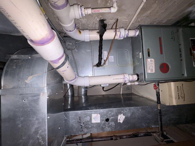 Completed full replacement of two 27-year-old HVAC systems in basement utility space. Installation included new furnace/air handler units, electrical disconnect panels with proper grounding, PVC drainage piping with appropriate fittings, condensate drain pans, and associated ductwork connections to ensure complete system functionality and code compliance.