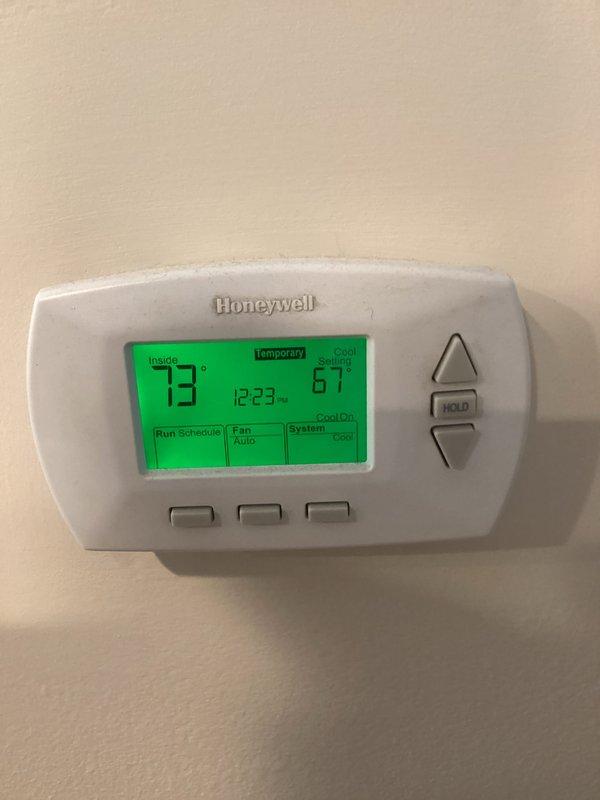 Performed routine HVAC maintenance agreement service. Replaced 16x20x1 air filter in system. Inspected condensate drain pan and safety float switch assembly, noting normal wear and operational condition. Verified thermostat operation showing system cooling properly with indoor temperature at 73°F and setpoint at 67°F. Confirmed programmable schedule active and fan set to auto mode. System operating within normal parameters. Documented equipment condition with photographs for service records.