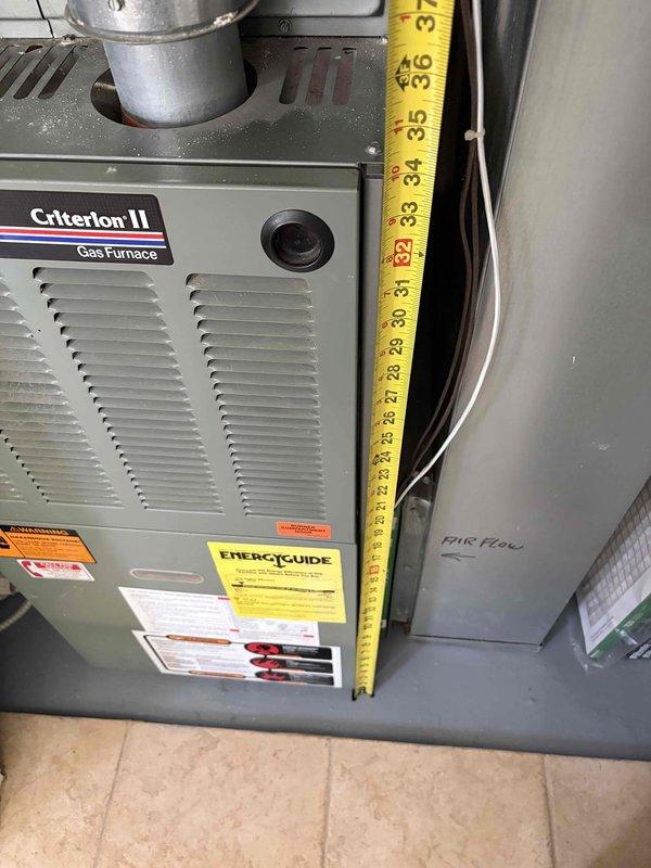 Conducted comprehensive evaluation of existing Rheem Criterion II gas furnace system for full replacement estimate. Unit assessed is a 25+ year old installation showing signs of age-related wear and obsolescence. Performed detailed measurements of existing equipment dimensions and clearances within utility closet installation space to determine replacement specifications. Documented current system configuration including furnace cabinet dimensions, supply and return air plenum connections, gas line routing, venting arrangement, and electrical connections. Installation location provides favorable working conditions with ground-level access eliminating need for ladder work. Photographed existing equipment condition, spatial constraints, and all utility connections to support accurate equipment sizing and installation planning for proposed replacement system.