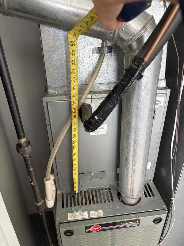 Conducted comprehensive evaluation of existing Rheem Criterion II gas furnace system for full replacement estimate. Unit assessed is a 25+ year old installation showing signs of age-related wear and obsolescence. Performed detailed measurements of existing equipment dimensions and clearances within utility closet installation space to determine replacement specifications. Documented current system configuration including furnace cabinet dimensions, supply and return air plenum connections, gas line routing, venting arrangement, and electrical connections. Installation location provides favorable working conditions with ground-level access eliminating need for ladder work. Photographed existing equipment condition, spatial constraints, and all utility connections to support accurate equipment sizing and installation planning for proposed replacement system.