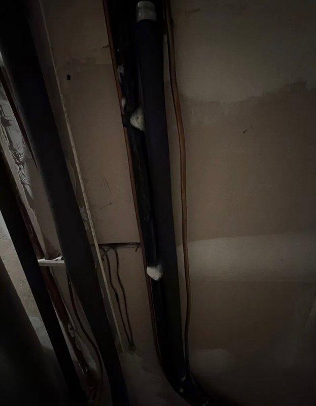 Responded to a no cooling call and diagnosed a refrigerant leak at the air handler suction line copper fitting, evidenced by green oil staining. The leak location was easily accessible in the basement utility area. Documented the refrigerant leak with photos showing the affected copper piping and brass fittings at the air handler connection point.