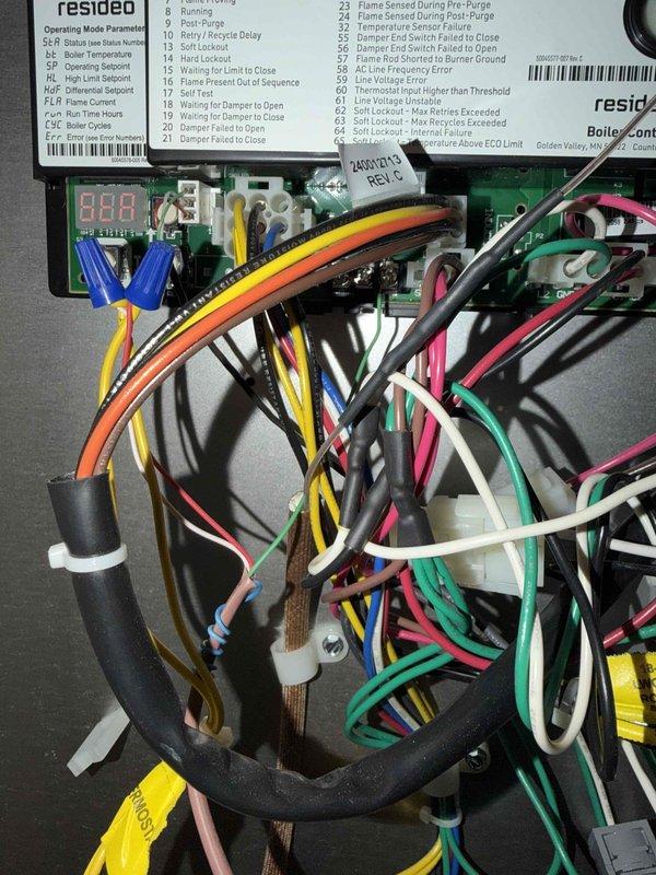 Responded to callback for thermostat communication failure on recently installed heating system. Upon arrival, accessed boiler control board and inspected wiring connections between thermostat and Resideo control module. Verified proper wire terminations, checked for loose connections in multi-conductor harness, and tested communication signals. Documented system configuration and control board diagnostic codes to ensure proper operation. System tested successfully with thermostat responding appropriately to commands.