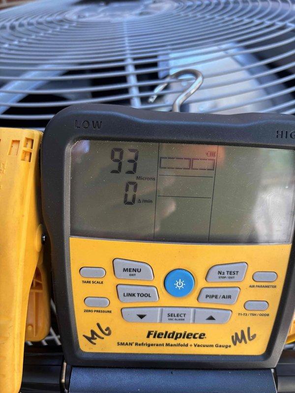 Completed full air conditioning system replacement including outdoor condensing unit and indoor evaporator coil. Removed existing equipment and installed new Carrier brand condenser unit on composite pad against exterior brick wall. Connected refrigerant lines, electrical service, and condensate drainage. Performed proper evacuation of refrigerant system, achieving vacuum level of 93 microns as verified with digital manifold gauge, ensuring system integrity and absence of moisture or contaminants. Energized system and confirmed proper operation of all components.