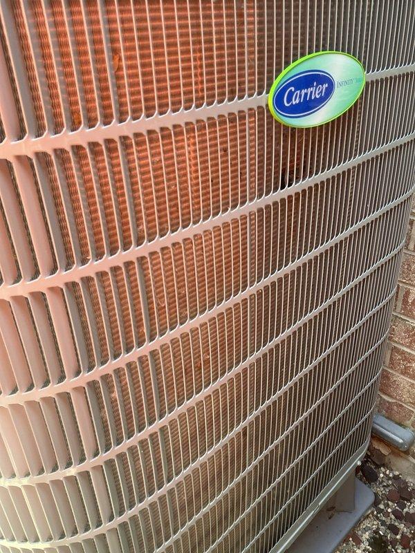 Completed preventative maintenance on Carrier condenser unit as part of annual HVAC agreement. Inspected outdoor unit condenser coils showing weathering and dirt accumulation, verified refrigerant line connections, and examined control board wiring and electrical components inside air handler compartment. All system controls, circuit boards, and wiring connections found secure and operational during inspection.