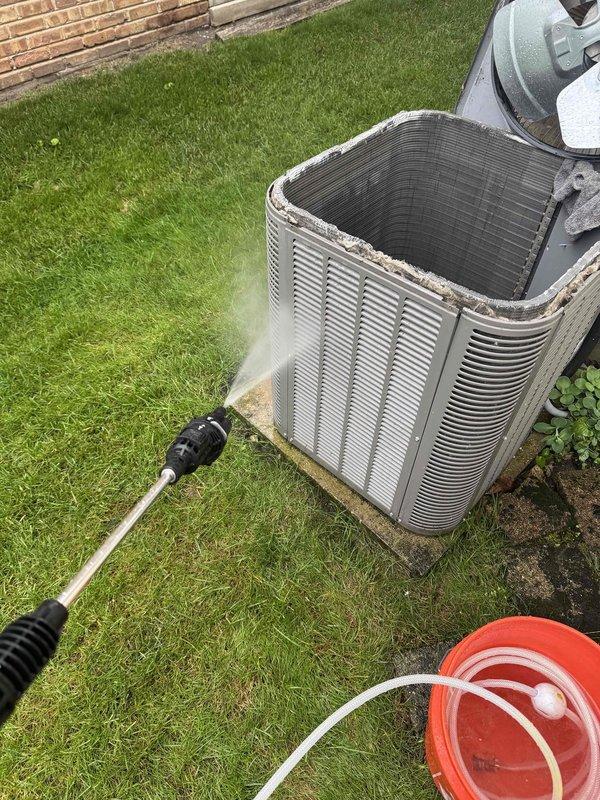 Returned to property to complete outdoor maintenance on residential air conditioning system. Performed thorough coil cleaning of condenser unit using pressure washing equipment to remove accumulated dirt and debris from exterior fins. Verified electrical readings using digital clamp meter, recording amperage draw of 1.92 amps and secondary reading of 0.262. All electrical connections and conduit inspected and found secure. Unit operating within normal parameters following maintenance completion.