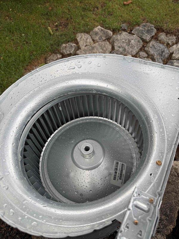 Returned to property for third blower wheel cleaning as part of comprehensive system maintenance. Accessed air handler unit and documented extensive contamination including heavy dust accumulation and mold growth on interior surfaces and compartment walls. Removed blower wheel assembly from unit and performed thorough cleaning to restore proper airflow and system efficiency. Component exhibited significant debris buildup that was affecting system performance. Cleaned and reinstalled blower wheel, ensuring proper operation before closing unit.