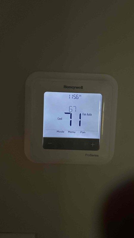 Completed preventive maintenance agreement service on dual condenser system. Inspected air handler unit in attic space with spray foam insulation, verified proper operation and documented equipment condition. Confirmed thermostat functionality on Honeywell ProSeries unit displaying proper cooling mode and fan settings.