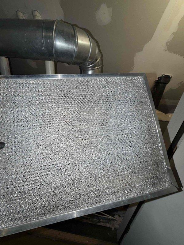 Completed comprehensive HVAC maintenance agreement service on multi-unit system including 5 air conditioning units, 2 air handlers, 1 electronic air cleaner, and replaced filters as specified in agreement. Performed diagnostic testing with clamp meter showing 13.72 amp draw on condensing unit, inspected and cleaned mesh filters showing moderate dust accumulation, and evaluated all accessible equipment including relocated third-floor unit behind closet. Noted active ceiling leak requiring follow-up repair and documented system conditions with photos for service records.