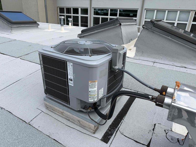 Completed comprehensive maintenance service on rooftop-mounted air conditioning system accessible via ladder from upper deck. Performed full system inspection of condenser unit including visual assessment of cabinet condition, refrigerant line connections, and rooftop installation integrity. Inspected copper refrigerant lines for proper insulation and signs of wear or damage, verified secure mounting of condensing unit on rooftop platform, and confirmed proper drainage around equipment. Checked condenser coil fins for debris accumulation, assessed fan guard and top grille condition, and documented equipment specifications from manufacturer labels. All components found in good operational condition with no immediate service needs identified. System operating within normal parameters upon completion of maintenance agreement inspection.