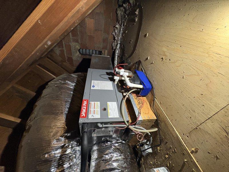 Evaluated attic-mounted York space pak system with documented refrigerant leak history and water leakage issues. Inspected air handler unit, refrigerant lines, condensate drain system, and ductwork connections. Documented equipment condition and measurements. Provided comprehensive replacement options for complete system due to ongoing refrigerant leak concerns and water intrusion problems affecting unit performance and reliability.