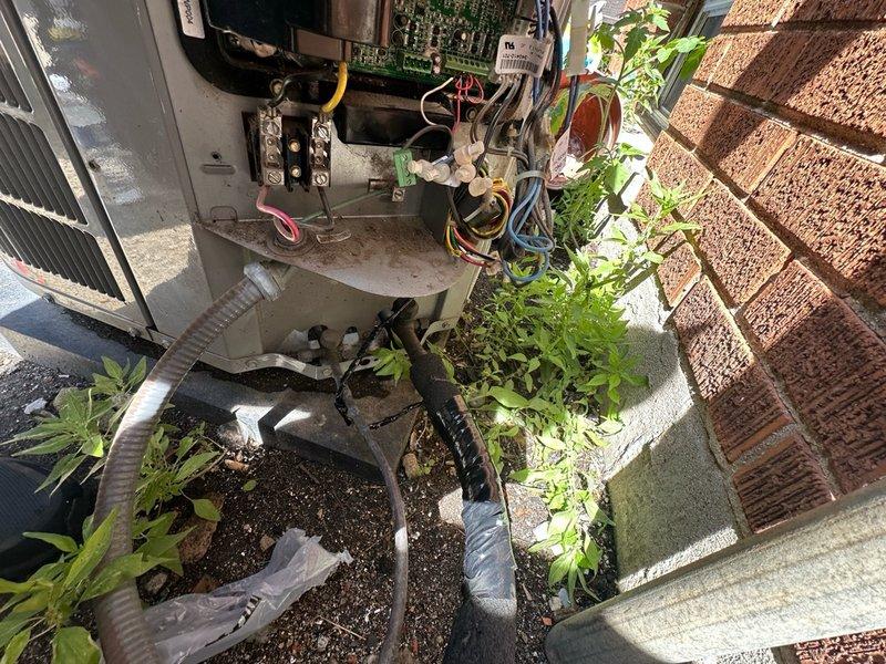Completed preventive maintenance on outdoor air conditioning unit per maintenance agreement terms. Inspected control board, electrical connections, and wiring harness; verified all terminal connections secure and system operational. Accessed unit through rear entrance per customer request due to front doorbell malfunction.