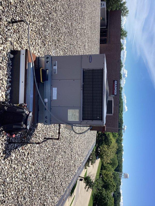 Completed commercial preventive maintenance agreement service on rooftop Carrier RTU. Inspected compressor, refrigerant lines, and electrical connections; all components found in normal operating condition with typical weathering consistent with outdoor exposure. Documentation photos captured for service records.