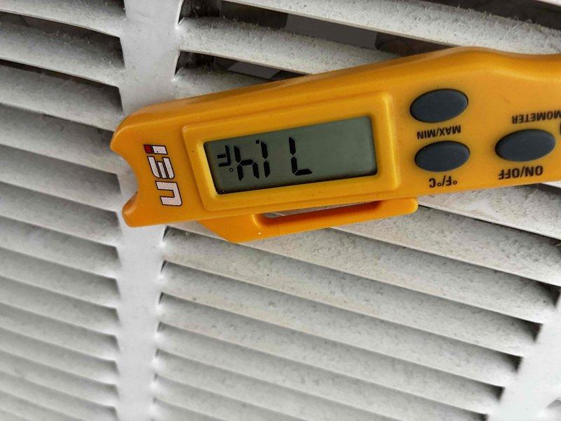 Responded to no cooling complaint on rooftop package unit. Upon arrival, tested supply air temperature at return grille which registered a FAIL reading on digital thermometer, confirming inadequate cooling performance. Inspected outdoor condensing unit on roof, noting system operational status and documented refrigerant line connections and mounting configuration for further diagnostic evaluation.