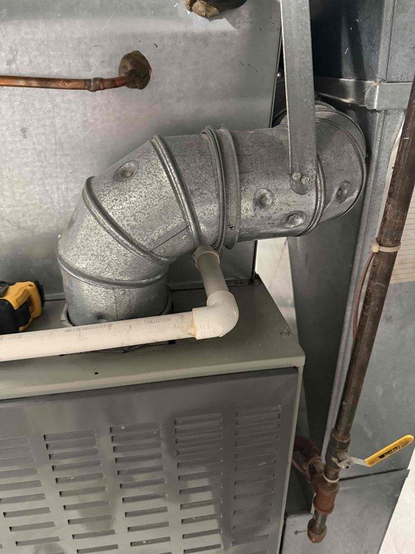 Completed comprehensive estimate for replacement of 22-year-old furnace system that has reached end of operational lifespan. Assessed existing HVAC equipment including air handler unit, ductwork connections, and condensate drainage system. Documented current system configuration with metallic duct elbows, cabinet housing, copper refrigerant lines showing age-related oxidation, and PVC condensate piping. Provided replacement recommendations and specifications for new high-efficiency heating system to restore reliable climate control functionality.