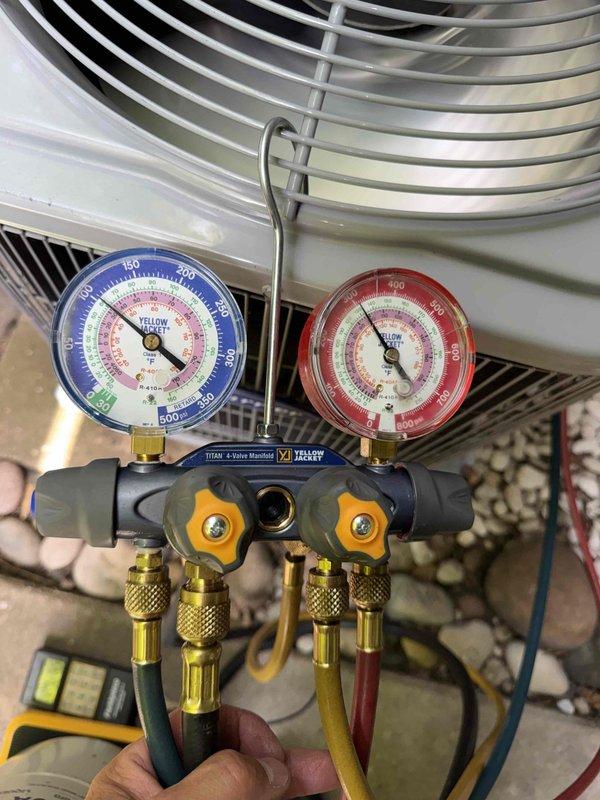 Returned to system to add refrigerant as scheduled. Connected Yellow Jacket Titan 4-valve manifold gauges to measure system pressures and verify refrigerant levels. Used Fieldpiece SRS1 refrigerant scale with alarm to accurately measure and charge system to manufacturer specifications. System pressures restored to proper operating range and unit returned to normal operation.