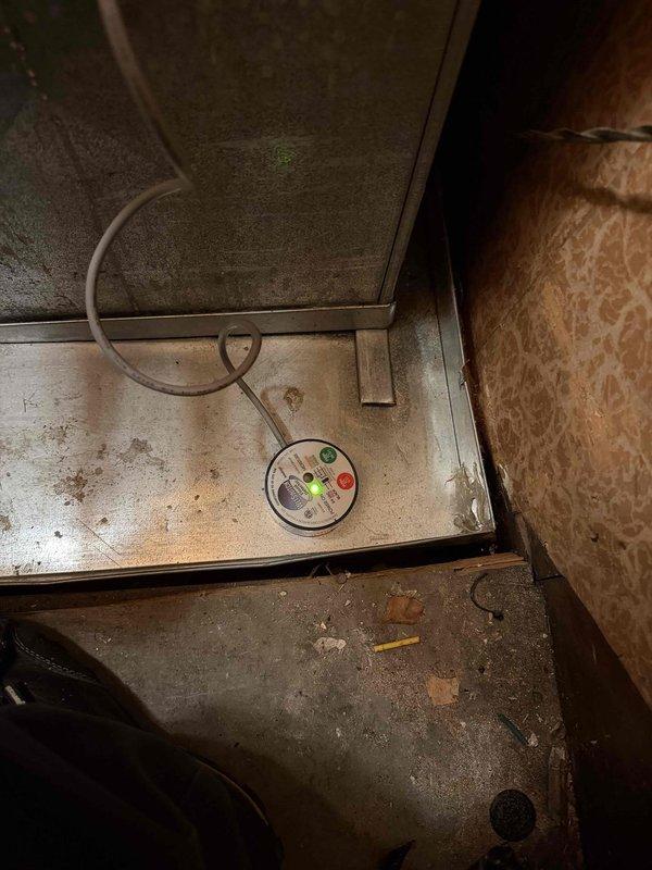 Responded to no cooling call and arrived on site to diagnose air conditioning system that was completely off. Performed system diagnostics using digital measurement tools and inspected refrigerant lines, recording a temperature reading of 57.3 degrees at the copper line. Documented equipment condition with photos showing HVAC unit with diagnostic gauge displaying indicator lights and overall system status for further assessment and repair recommendations.
