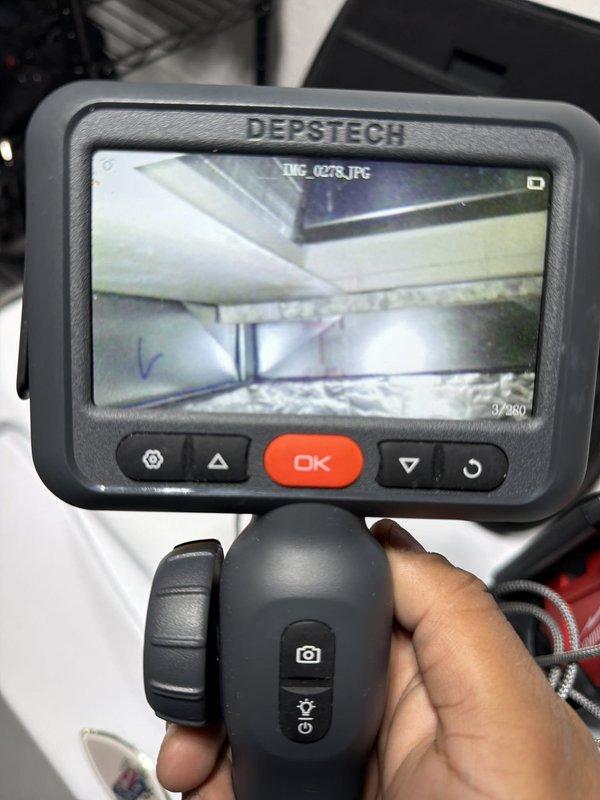 Responded to callback for coil freezing issue on recently installed AC-only system. Performed diagnostic inspection of furnace blower operation using multimeter and borescope camera to assess airflow and internal ductwork conditions. Investigated potential airflow restrictions at filter housing and humidity control unit, documenting system configuration and internal duct conditions for further analysis of inadequate air circulation causing coil freeze-up.