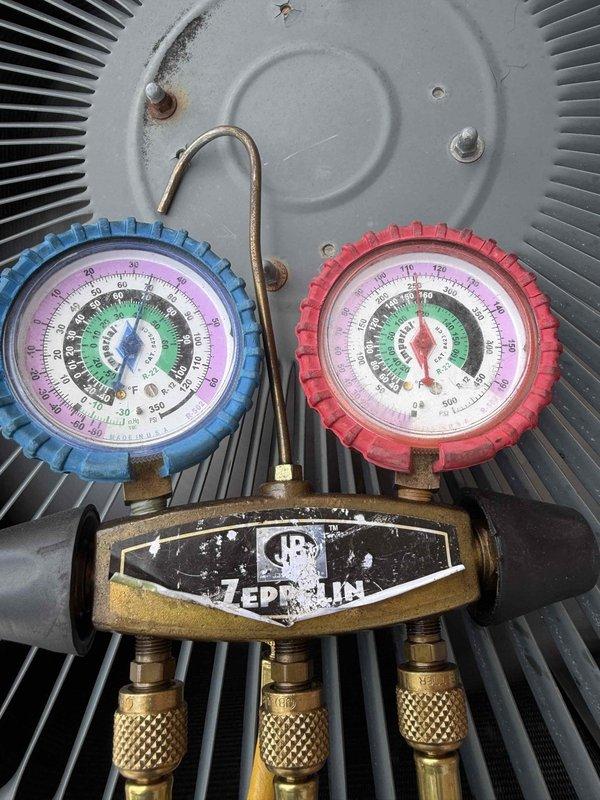Responded to no cooling complaint on 10+ year old system. Found evaporator coil completely iced over due to blower motor failure. Connected manifold gauges to assess system pressures after coil defrosted. Blower motor inoperative, preventing proper airflow across evaporator coil and causing ice buildup. Quoted customer for blower motor replacement and necessary repairs to restore cooling function.