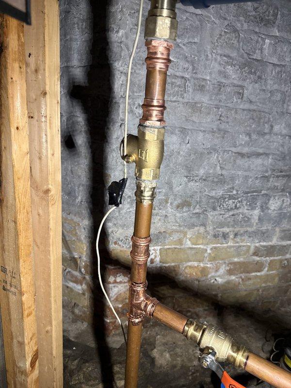 Responded to callback regarding low water pressure alerts occurring over the past week. Inspected plumbing installation in basement mechanical room, including copper supply lines, brass compression fittings, and electronic pressure monitoring device mounted on concrete block wall. Evaluated system connections, valve operations, and pressure regulation components to identify source of PSI drops. Verified all brass fittings and joints were properly secured and checked for potential leaks or air infiltration that could affect pressure readings. Tested pressure monitoring device functionality and confirmed system integrity to ensure no immediate risk of system failure or water damage.