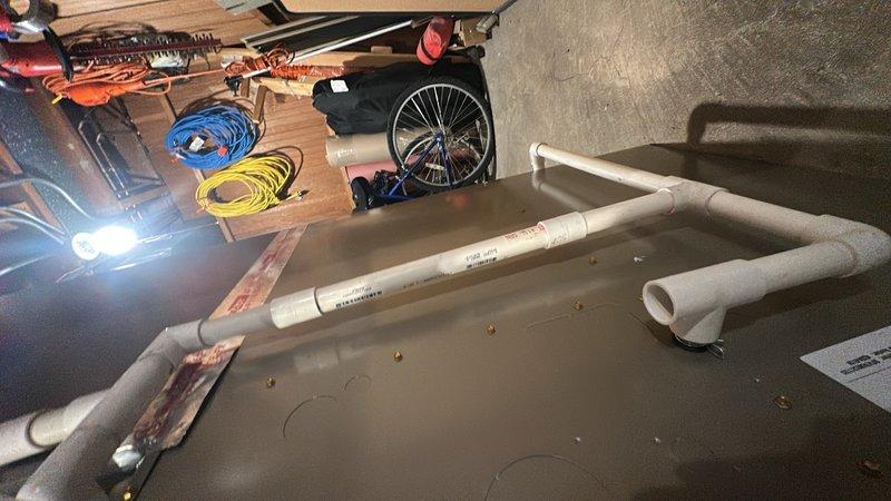 Responded to no cooling call on system less than one year old. Upon arrival, determined that safety float switch in drain pan had tripped due to condensate backup, shutting down the unit as designed. Cleared condensate line blockage, verified proper drainage, and reset float switch. Tested system operation and confirmed unit cooling properly with normal airflow and temperature split.