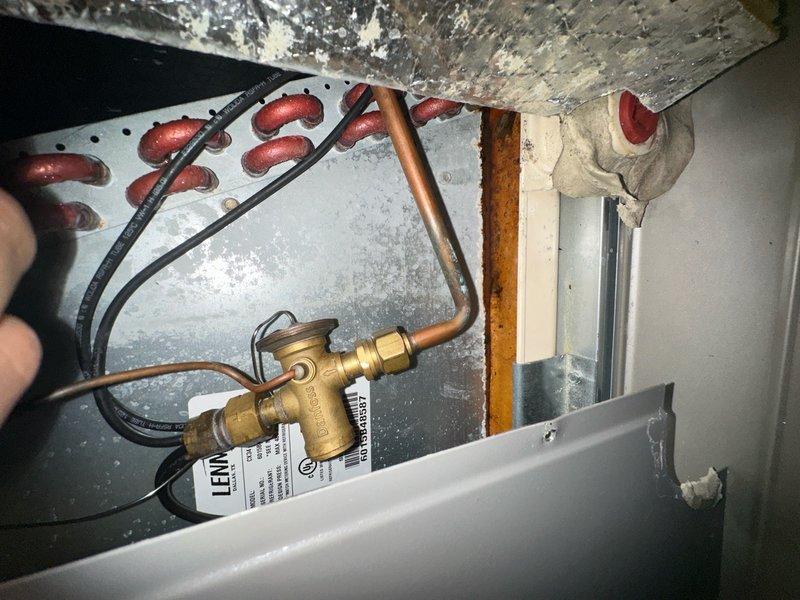 Responded to no cooling call on system less than one year old. Upon arrival, determined that safety float switch in drain pan had tripped due to condensate backup, shutting down the unit as designed. Cleared condensate line blockage, verified proper drainage, and reset float switch. Tested system operation and confirmed unit cooling properly with normal airflow and temperature split.