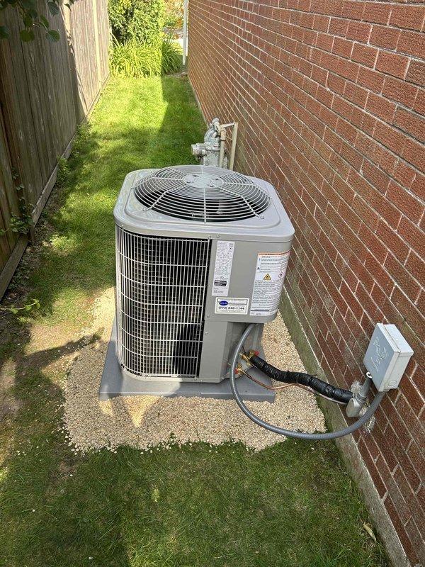 Completed full air conditioning system replacement including outdoor condensing unit and indoor evaporator coil. Installed new Bryant-compatible outdoor A/C unit on existing concrete pad with proper refrigerant line connections and electrical disconnect, ensuring adequate clearance from brick wall and fence. Replaced indoor evaporator coil above existing furnace, integrated new condensate drain lines with PVC piping, and verified all ductwork connections with proper insulation at joints to prevent air leakage and condensation issues.