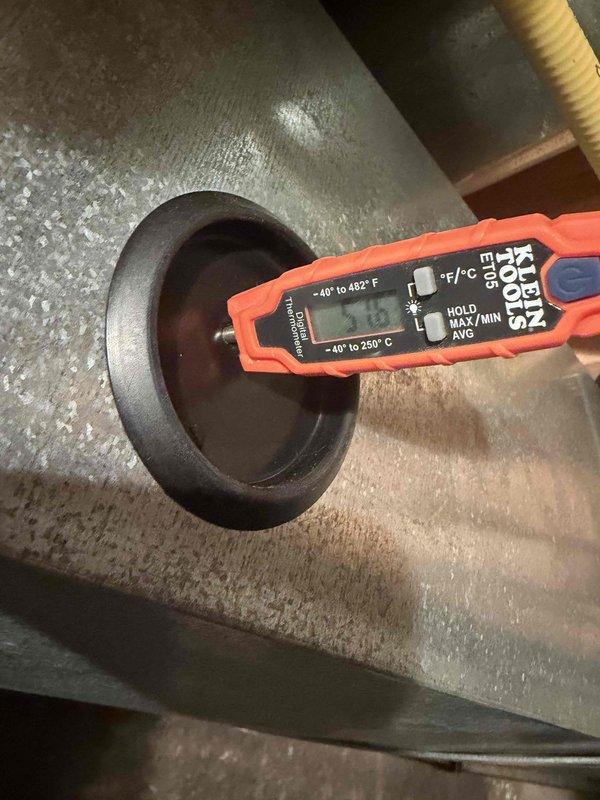 Responded to no-cool call on recently installed AC system with blank thermostat displaying offline status in app. Performed diagnostic inspection of indoor air handler and blower assembly, taking temperature measurements at supply plenum to verify system operation. Identified thermostat communication issue preventing system startup and restored proper function, confirming adequate airflow and refrigerant temperatures throughout system.