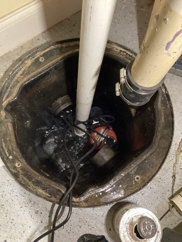 Responded to emergency call for water backing up into basement. Performed camera inspection of main sewer line to diagnose the cause of the backup. Removed and serviced the existing sump pump system, which showed signs of wear and contamination. Cleaned the sump basin, removed debris, and reinstalled pump components with proper discharge piping connections. Verified system operation and confirmed water was being properly evacuated from the basement area to prevent further flooding.