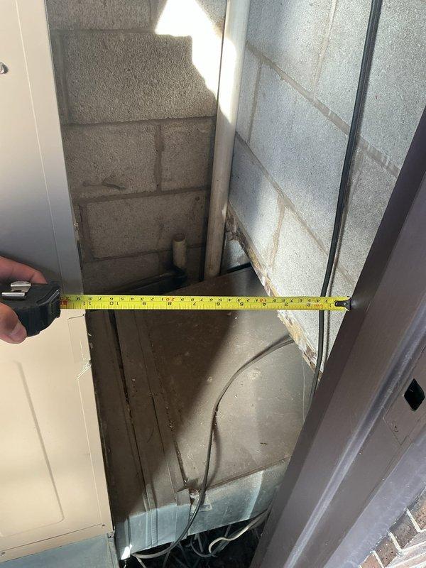 Responded to no cooling complaint on 4-year-old AC system in apartment unit. Upon arrival, encountered severely restricted access to equipment due to extremely narrow mechanical space with limited clearance around air handler. Documented space constraints with measurements and photographs showing concrete block enclosure with minimal working room. Due to physical access limitations preventing standard service procedures, coordinated technician reassignment to complete necessary diagnostics and repairs with personnel better suited for confined space work.