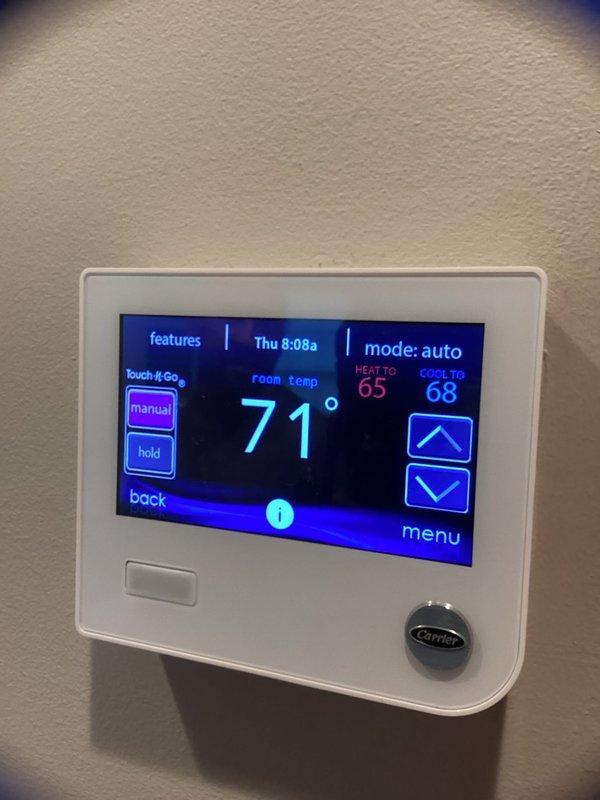 Completed scheduled HVAC maintenance agreement service on CC 1 condenser unit. Verified Carrier thermostat operation showing proper functionality in auto mode with heat setpoint at 65° and cool setpoint at 68°, current room temperature reading 71°. Inspected ductwork and plenum assembly with reflective foil-faced insulation in satisfactory condition. Customer typically provides their own 24x24 dynamic filter as this is not included in the maintenance agreement. System operational and performing within normal parameters.