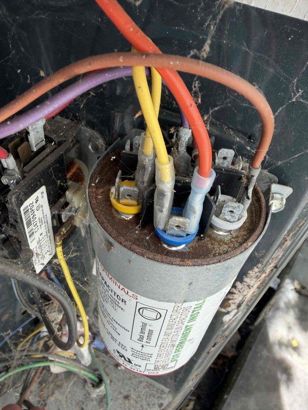 Completed comprehensive HVAC maintenance agreement service on two air conditioning systems, with one unit excluded per customer request. Performed standard fall preventive maintenance inspections including examination of electrical components, capacitors, and control systems. Observed significant corrosion and rust on capacitor mounting hardware and terminal connections, along with aged wiring showing discoloration; noted thermostat displaying low battery warning requiring replacement. All systems operational at time of service completion with photographic documentation captured for maintenance records.