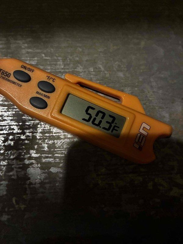 Responded to no cooling complaint on residential AC unit installed less than two years prior. Upon inspection, measured supply air temperature at 50.3°F at the evaporator coil, indicating system is producing adequate cooling but insufficient airflow or distribution issues may be present. Documented conditions of air handler compartment and concrete pad showing moisture staining, suggesting potential condensate drainage concerns that require monitoring.