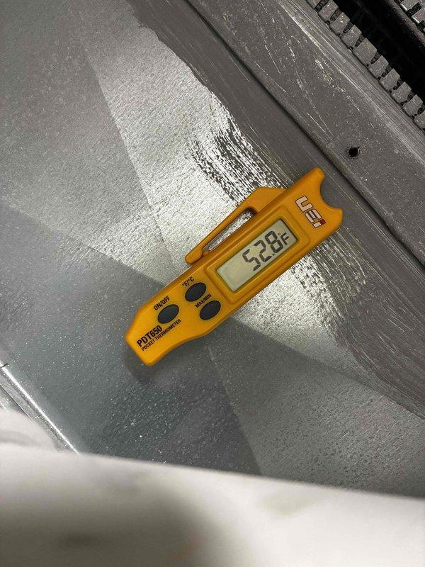Responded to no cooling complaint on 9-year-old Carrier air conditioning system. Upon arrival, found red indicator light on Honeywell thermostat and confirmed unit running but no cool air delivery. Performed system diagnostics and identified failed dual run capacitor with severe corrosion and rust on terminals. Measured supply air temperature at 53.8°F, confirming inadequate cooling performance. Replaced defective capacitor with new TITAN TRCFD455 dual run capacitor, restored proper system operation, and verified cooling performance. System now operating within normal parameters with proper airflow and temperature differential.
