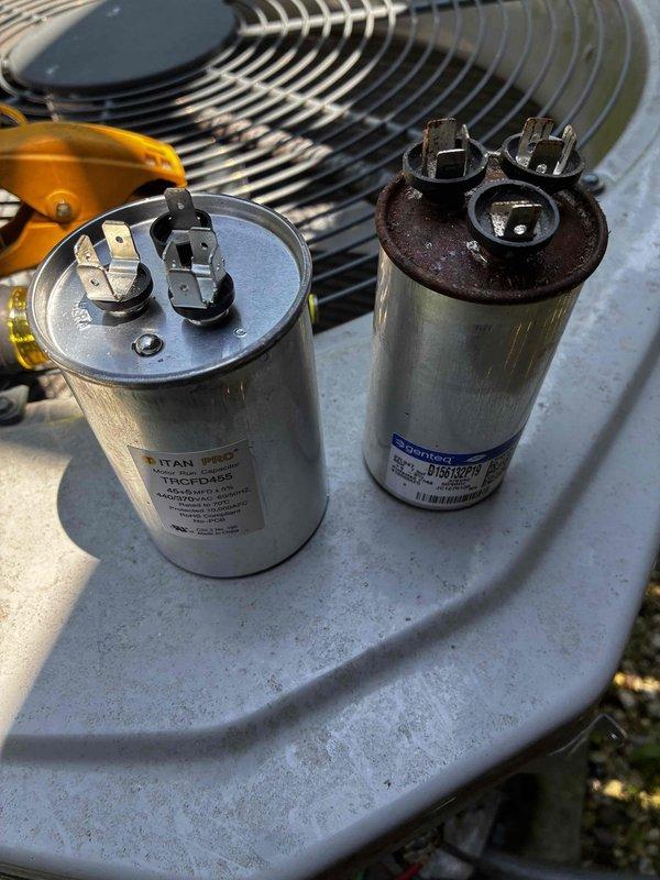 Responded to no cooling complaint on 9-year-old Carrier air conditioning system. Upon arrival, found red indicator light on Honeywell thermostat and confirmed unit running but no cool air delivery. Performed system diagnostics and identified failed dual run capacitor with severe corrosion and rust on terminals. Measured supply air temperature at 53.8°F, confirming inadequate cooling performance. Replaced defective capacitor with new TITAN TRCFD455 dual run capacitor, restored proper system operation, and verified cooling performance. System now operating within normal parameters with proper airflow and temperature differential.