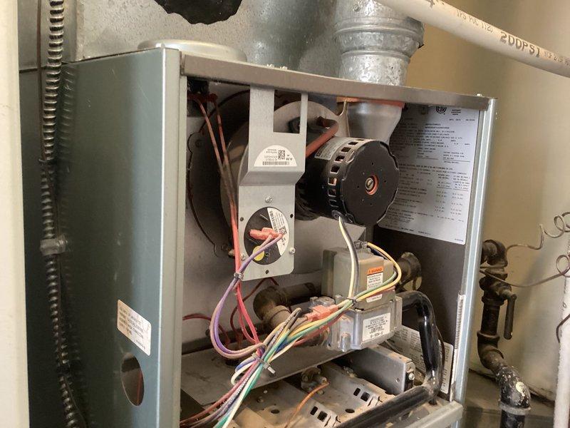 Responded to no cooling complaint on residential HVAC system less than 10 years old. Upon arrival, accessed indoor air handler unit and inspected internal components including blower motor, electrical connections, and control boards. Proceeded to outdoor condenser unit where compressor was found to be inoperative. Removed failed compressor from outdoor unit and staged replacement component on-site. Documented existing refrigerant line connections and electrical wiring configuration. System required compressor replacement to restore cooling functionality.