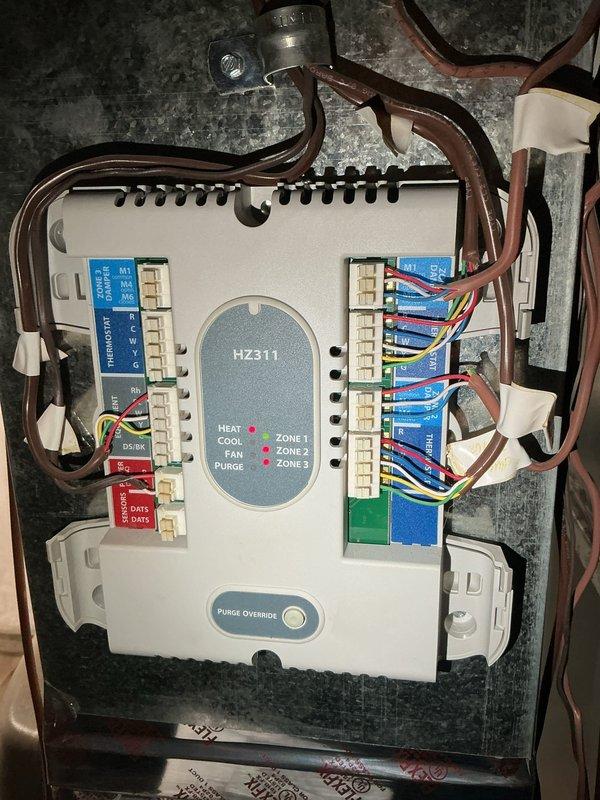 Responded to third callback for AC unit not cooling properly. Upon arrival, inspected multi-zone HVAC system control board (HZ311 zone controller) and verified all zone wiring connections, LED indicators, and system operation modes. Checked Honeywell digital thermostat displaying 69°F setpoint in cooling mode with Wi-Fi connectivity enabled. Diagnosed and resolved persistent cooling issue by addressing control board communication fault between zone controller and thermostat. Tested all three zones for proper airflow and temperature response. System now operating within normal parameters with all zones cooling effectively.