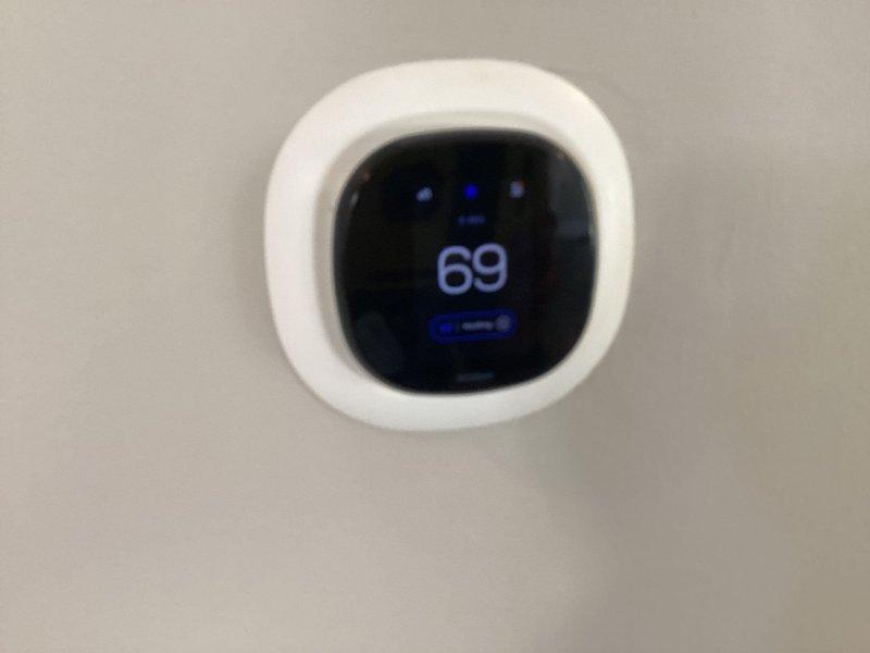 Performed comprehensive system evaluation for new homeowner transitioning service providers. Inspected air handler unit in attic space, documented equipment information including model and serial numbers for warranty transfer purposes. Verified all electrical connections, control board operation, and capacitor functionality. Confirmed thermostat communication and temperature control settings at 69 degrees. System operating within normal parameters with no cooling deficiencies identified at time of inspection.