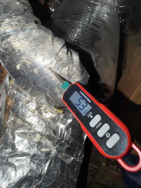 Responded to no cooling complaint on one-year-old system experiencing inadequate cooling from 3:00 PM through 9:30 PM daily. Performed diagnostic testing of supply air temperatures at ceiling register, recording measurements to verify cooling output. Inspected attic ductwork and identified issues with flexible duct installation showing signs of deterioration and inadequate insulation coverage. Measured supply air temperature at duct run reading 23.7°F temperature differential, indicating potential airflow restriction or heat gain through compromised duct insulation. Documented conditions with photos for further evaluation and recommended ductwork remediation to resolve afternoon cooling deficiency.