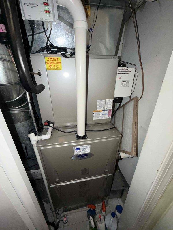 Responded to no cooling complaint and discovered evaporator coil completely frozen over with heavy ice accumulation on heat exchanger and refrigerant lines. Diagnosed frozen coil condition caused by restricted airflow or possible refrigerant issue. System was shut down to allow ice to thaw before further diagnostics could be performed to determine root cause and complete necessary repairs.