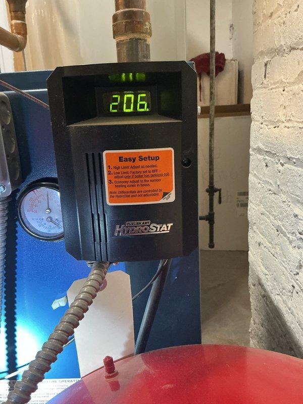 Responded to service call regarding boiler system concern with home temperature being excessively warm. Upon inspection, found Honeywell gas valve control unit and HydroStat digital control displaying 206°F, indicating system was actively operating. Verified boiler components including gas valve controls, pressure gauge readings, and digital temperature controller were functioning properly. Customer educated on normal system operation and thermostat adjustment to achieve desired comfort level.
