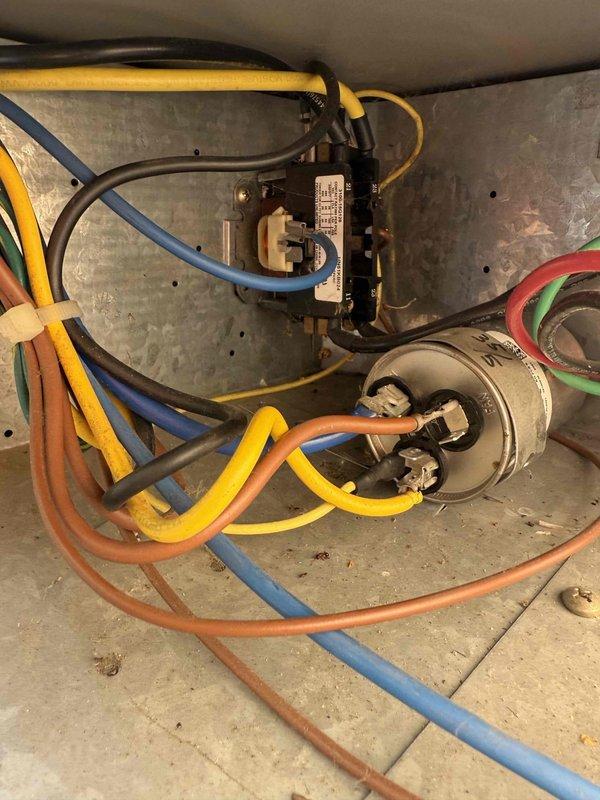 # HVAC Service Report - Cooling System Repair

Responded to no-cool complaint on 15-year-old residential air conditioning system. Upon arrival, performed comprehensive system inspection including visual examination of outdoor condensing unit components and indoor air handler. 

Inspection revealed aging electrical components in outdoor unit, including contactor and capacitor showing signs of wear and corrosion on mounting surfaces. Multiple wire connections were inspected and found secure, though unit exhibited typical wear patterns consistent with system age. Capacitor tested and found within acceptable operating parameters despite visible age-related surface deterioration.

Investigated reported pipe leaking concern by examining refrigerant lines, condensate drainage system, and all visible plumbing connections throughout the system. Inspected copper refrigerant lines running from outdoor unit to indoor air handler for signs of refrigerant leaks, corrosion, or moisture accumulation. 
