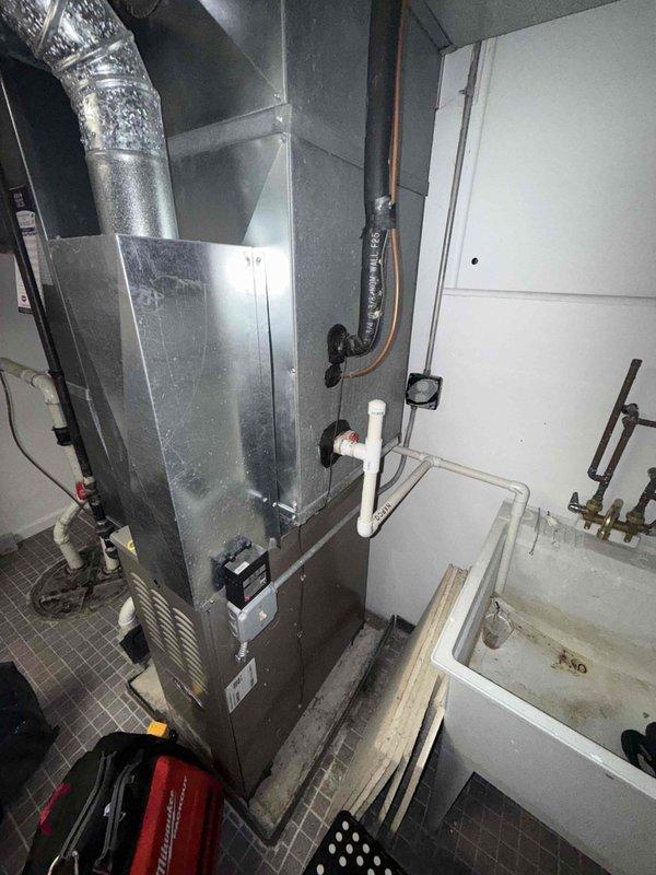 # HVAC Service Report - Cooling System Repair

Responded to no-cool complaint on 15-year-old residential air conditioning system. Upon arrival, performed comprehensive system inspection including visual examination of outdoor condensing unit components and indoor air handler. 

Inspection revealed aging electrical components in outdoor unit, including contactor and capacitor showing signs of wear and corrosion on mounting surfaces. Multiple wire connections were inspected and found secure, though unit exhibited typical wear patterns consistent with system age. Capacitor tested and found within acceptable operating parameters despite visible age-related surface deterioration.

Investigated reported pipe leaking concern by examining refrigerant lines, condensate drainage system, and all visible plumbing connections throughout the system. Inspected copper refrigerant lines running from outdoor unit to indoor air handler for signs of refrigerant leaks, corrosion, or moisture accumulation. 