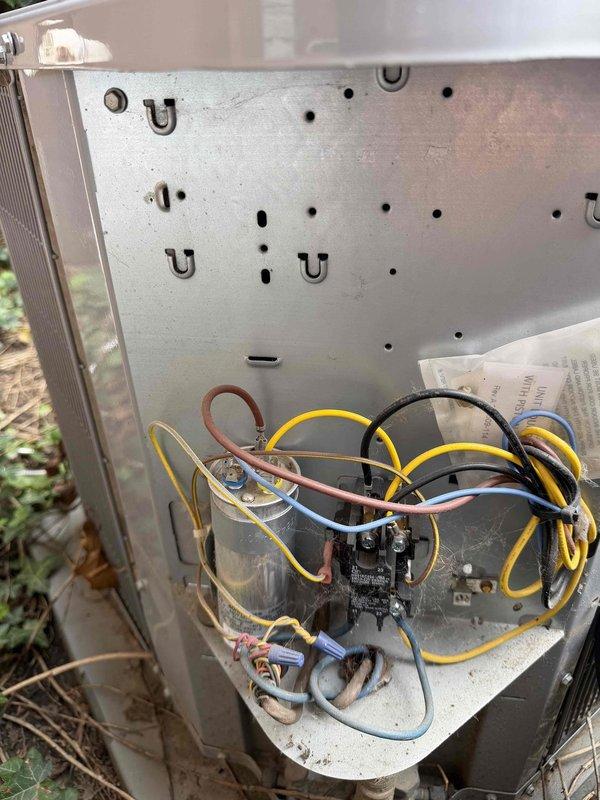# HVAC Service Report

Responded to no cooling complaint on residential air conditioning system. Upon arrival, confirmed outdoor condenser fan motor operating but unit not producing cold air. Removed access panel and inspected electrical components including contactor, dual run capacitor assembly, and wiring connections. Identified failed capacitor as root cause preventing compressor from starting while allowing fan motor to continue operation. Replaced defective capacitor with manufacturer-specified replacement, verified proper microfarad rating and voltage specifications. Tested contactor operation and inspected all wire terminations for secure connections. Cleared vegetation and debris from around unit base and fins to ensure adequate airflow. Restored power and confirmed compressor startup, verified proper amp draw on both compressor and fan motor circuits. System returned to normal cooling operation with appropriate temperature split across evaporator coil. Recommended ongoing veg