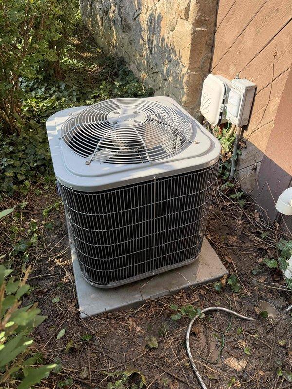 # HVAC Service Report

Responded to no cooling complaint on residential air conditioning system. Upon arrival, confirmed outdoor condenser fan motor operating but unit not producing cold air. Removed access panel and inspected electrical components including contactor, dual run capacitor assembly, and wiring connections. Identified failed capacitor as root cause preventing compressor from starting while allowing fan motor to continue operation. Replaced defective capacitor with manufacturer-specified replacement, verified proper microfarad rating and voltage specifications. Tested contactor operation and inspected all wire terminations for secure connections. Cleared vegetation and debris from around unit base and fins to ensure adequate airflow. Restored power and confirmed compressor startup, verified proper amp draw on both compressor and fan motor circuits. System returned to normal cooling operation with appropriate temperature split across evaporator coil. Recommended ongoing veg