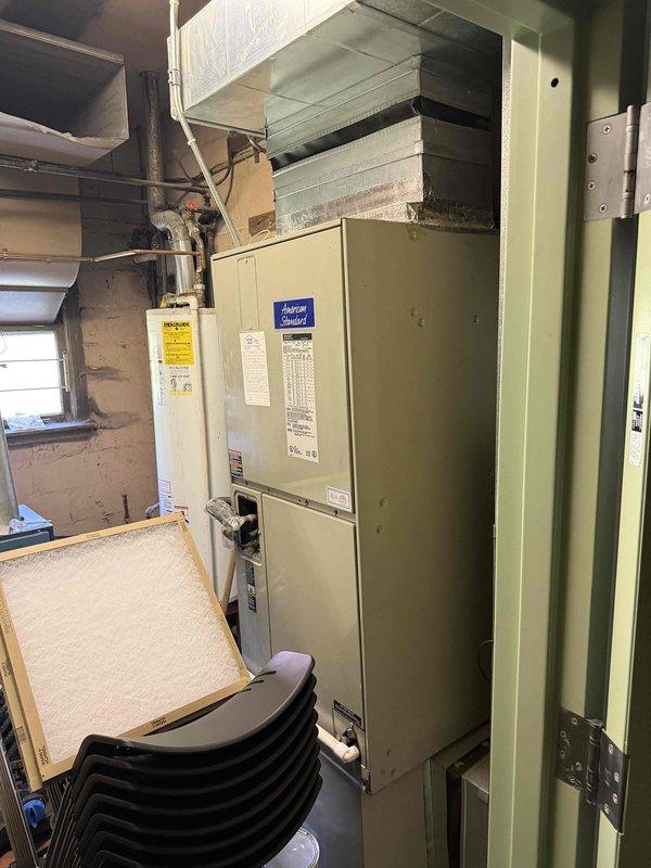 Provided estimate for replacement of existing 3.5 ton American Standard air handler unit located in basement utility room. Current equipment assessed and documented, including existing ductwork connections, condensate drainage system, electrical connections, and installation space constraints within mechanical chase area.
