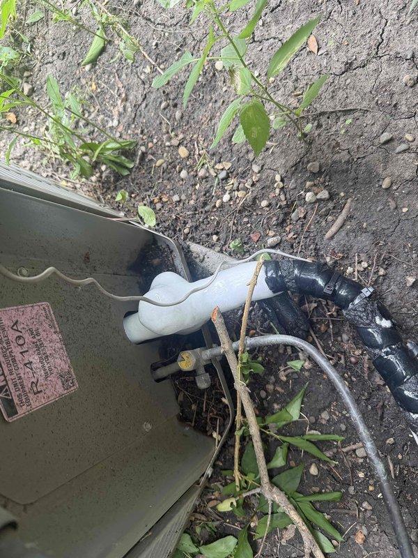 Responded to no cooling complaint on 10+ year old AC system. Upon inspection, found significant ice accumulation on refrigerant lines and insulation in indoor unit area, indicating restricted airflow or low refrigerant charge. System was making abnormal noise during operation. Inspected outdoor condensing unit and verified proper drainage system operation with PVC condensate lines functioning as designed. Heavy frost buildup on suction line confirmed cooling system malfunction requiring immediate attention to prevent compressor damage.
