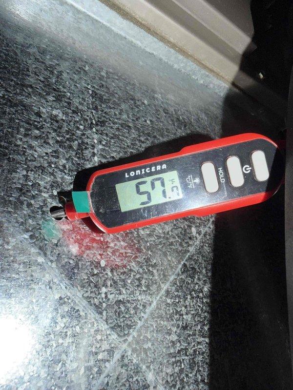 Responded to callback for AC not cooling and making noise. Upon arrival, found evaporator coil completely frozen over with heavy frost accumulation, measuring 57°F at the coil surface. Inspected electrical components and capacitor connections, which appeared intact with proper wiring configuration. Diagnosed frozen coil as result of restricted airflow due to lack of maintenance. System shutdown to allow coil to thaw before further evaluation could be completed.