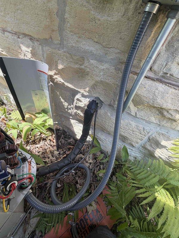 Installed surge protector at electrical panel to protect HVAC equipment from voltage spikes and power surges. Replaced existing electrical whip with new flexible conduit and wiring connecting outdoor AC unit to disconnect box, ensuring proper gauge wire and secure connections per manufacturer specifications and local electrical code requirements.