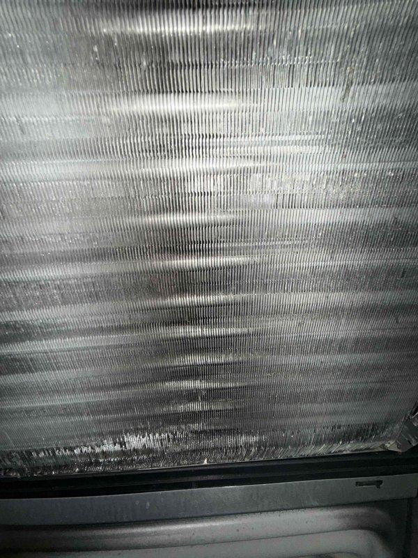 Completed cooling check on one air conditioning system as part of scheduled maintenance agreement. Inspected evaporator coil and found significant discoloration, staining, and accumulated dirt buildup between fins, indicating need for future cleaning to maintain optimal heat transfer efficiency. Performed diagnostic temperature measurements using infrared thermometer to verify system operation and cooling performance.